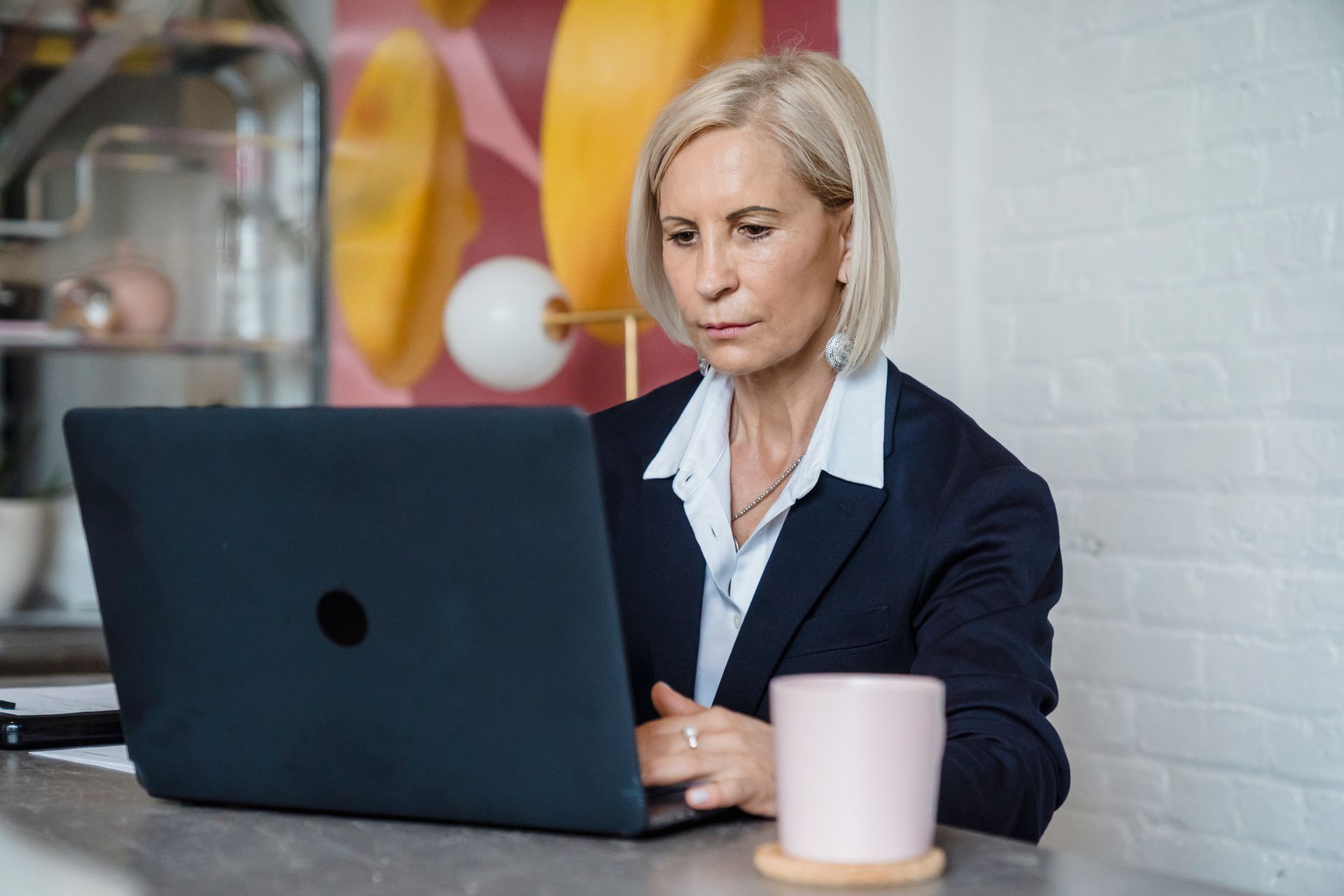A mature professional woman working on a laptop