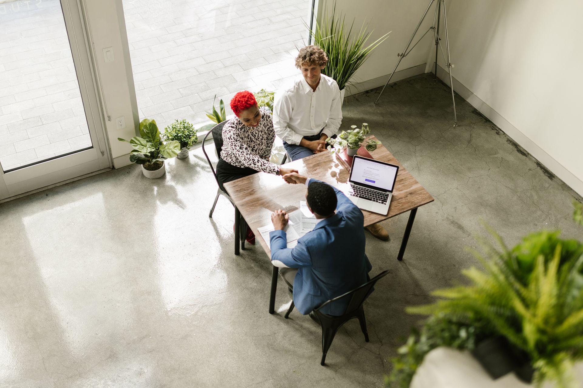 Two people in a bright office meeting, seen from above
